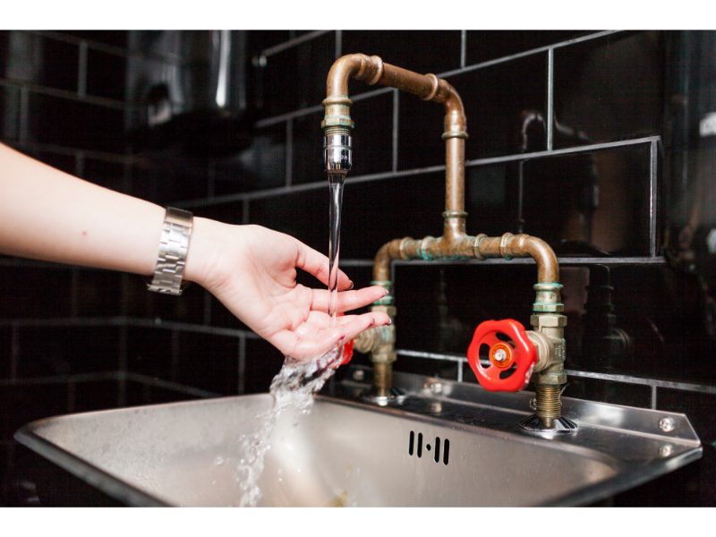 Woman washing hands at modern sink